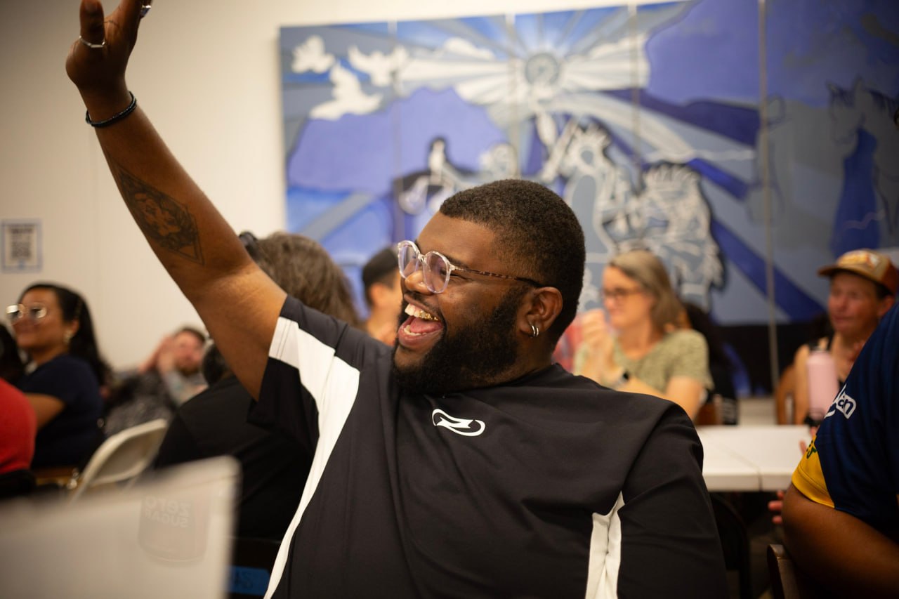A participant raising his hand during a community creative session